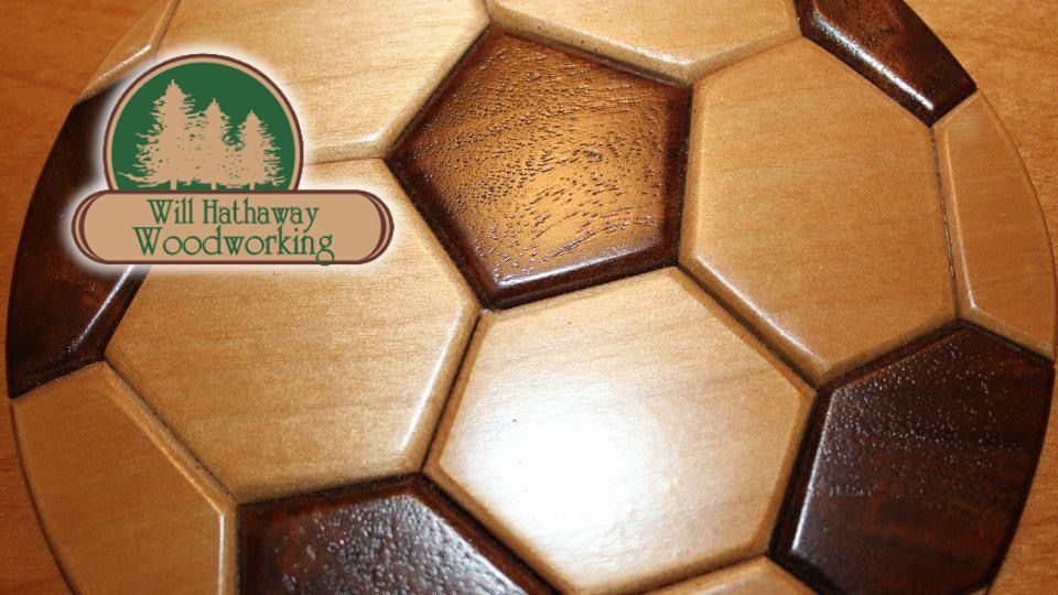 Will Hathaway Woodworking logo over an inlaid wooden soccer ball