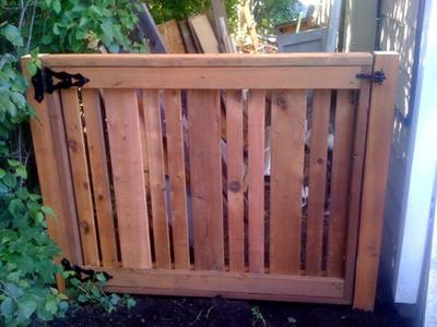 Wood slat gate with black hardware
