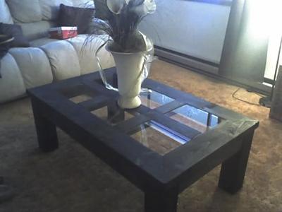 Dark coffee table with a glass top in a living room