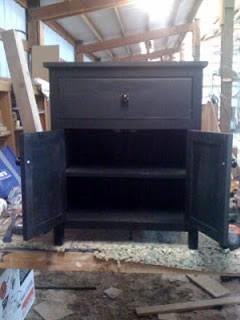 The black night stand with its doors open