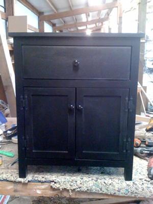 Black night stand with a drawer and two doors
